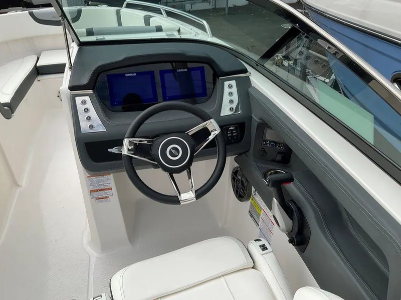 Slide: The Image of 2024 Chaparral 250 OSX boat cockpit with modern steering and dual displays. - 22