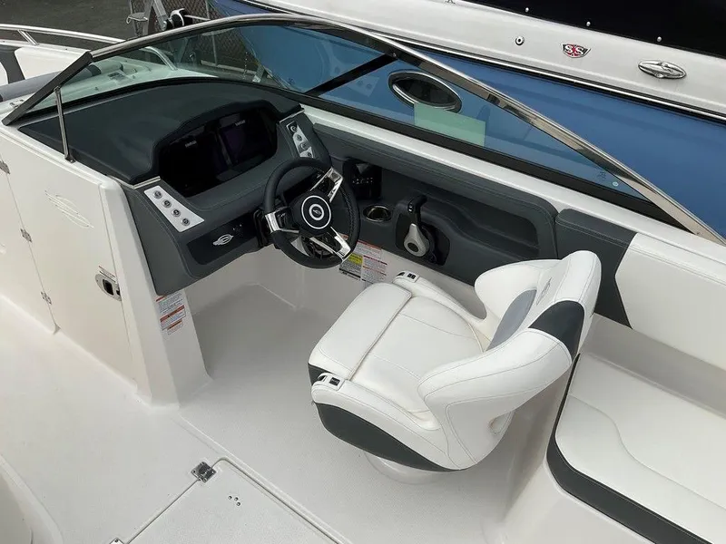Slide: The Image of 2024 Chaparral 250 OSX boat cockpit with modern steering and seating. - 23