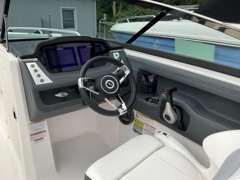 Slide: The Image of 2024 Chaparral 250 OSX boat cockpit with modern steering and dual displays. - 24
