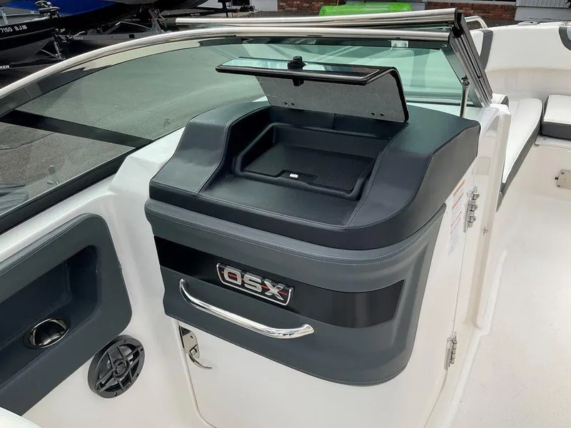 Slide: The Image of 2024 Chaparral 250 OSX boat interior with storage compartment and speaker. - 25