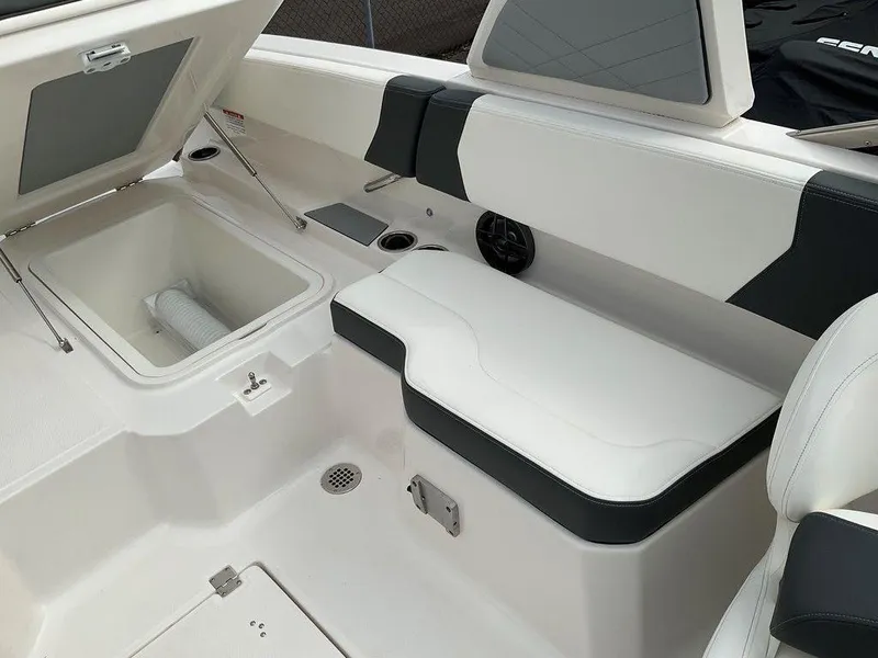 Slide: The Image of 2024 Chaparral 250 OSX boat interior with seating and storage compartment. - 29