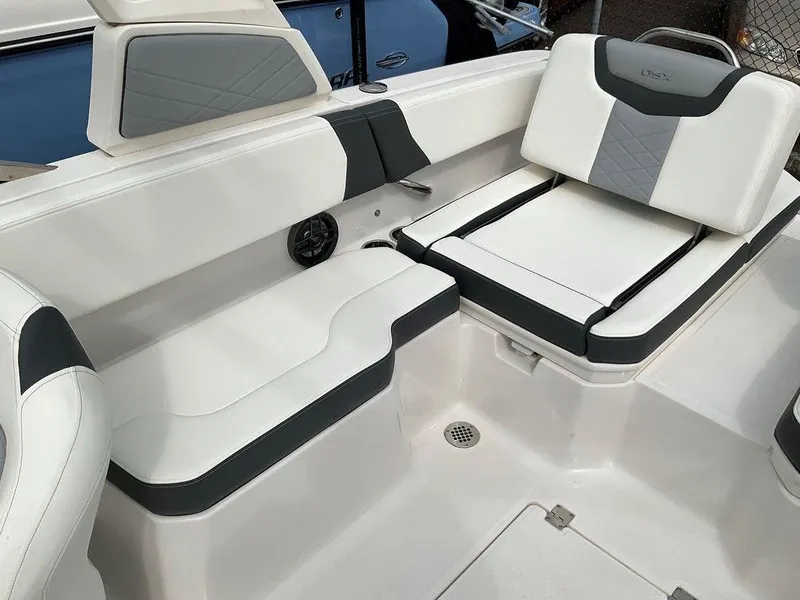 Slide: The Image of 2024 Chaparral 250 OSX boat interior with white and gray seating. - 31