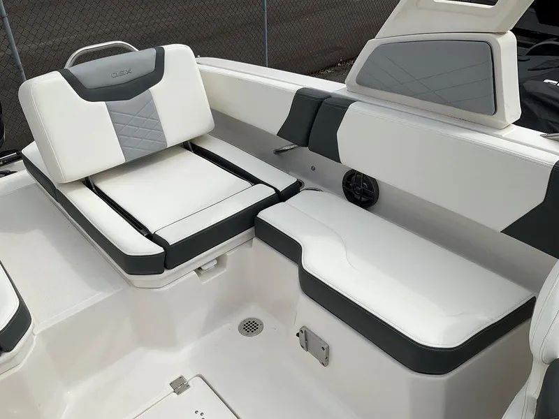 Slide: The Image of 2024 Chaparral 250 OSX boat interior with white and gray seating. - 32