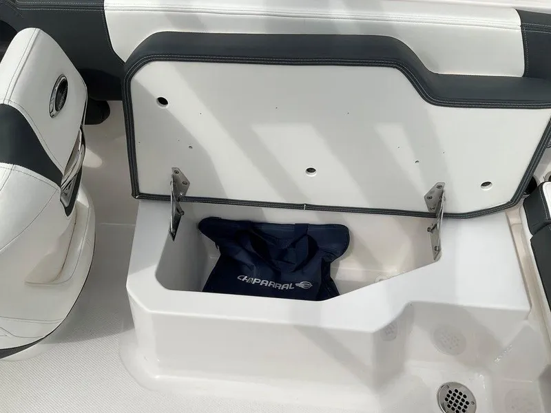 Slide: The Image of 2024 Chaparral 250 OSX boat storage compartment with branded bag inside. - 34