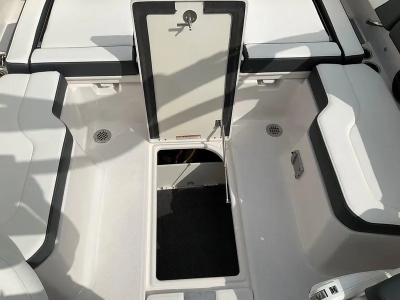 Slide: The Image of 2024 Chaparral 250 OSX boat interior with open storage compartment. - 43