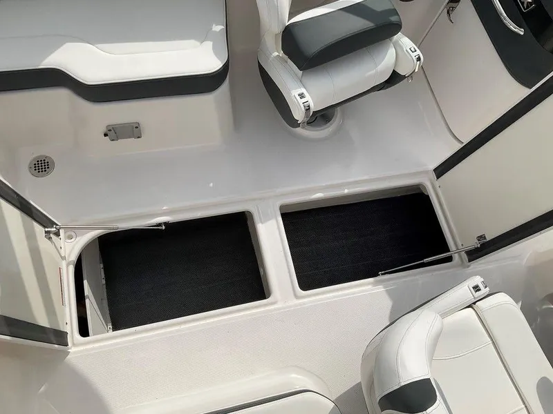 Slide: The Image of 2024 Chaparral 250 OSX boat interior with storage compartments and seating. - 44