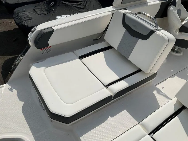 Slide: The Image of 2024 Chaparral 250 OSX boat seating with white and gray upholstery. - 47