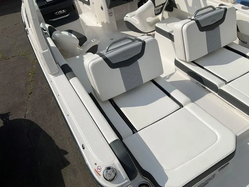 Slide: The Image of 2024 Chaparral 250 OSX boat interior with white and gray seating. - 48