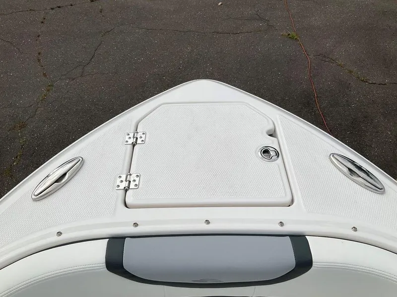 Slide: The Image of 2024 Chaparral 250 OSX boat bow with storage hatch and cleats. - 7
