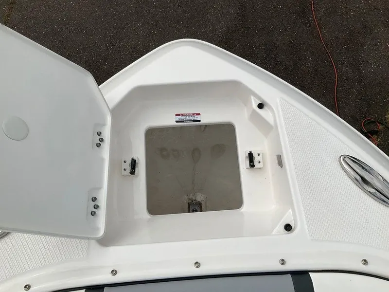 Slide: The Image of 2024 Chaparral 250 OSX boat storage compartment with open hatch. - 8