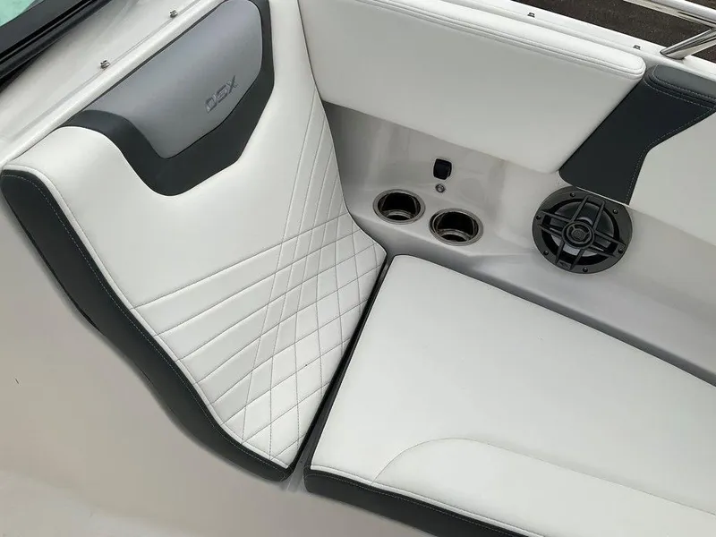 Slide: The Image of 2024 Chaparral 250 OSX boat interior with quilted seating and cup holders. - 9