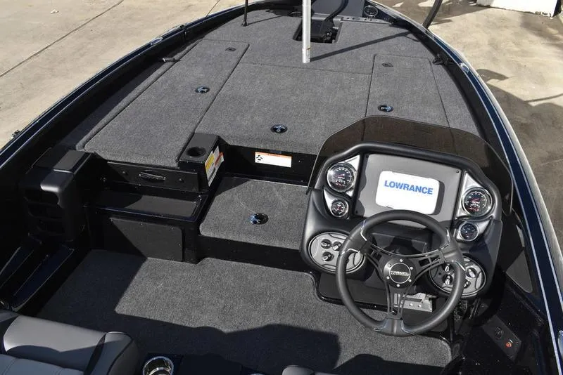 Slide: The Image of 2024 Triton 18 TrX boat interior with Lowrance electronics and spacious deck. - 11