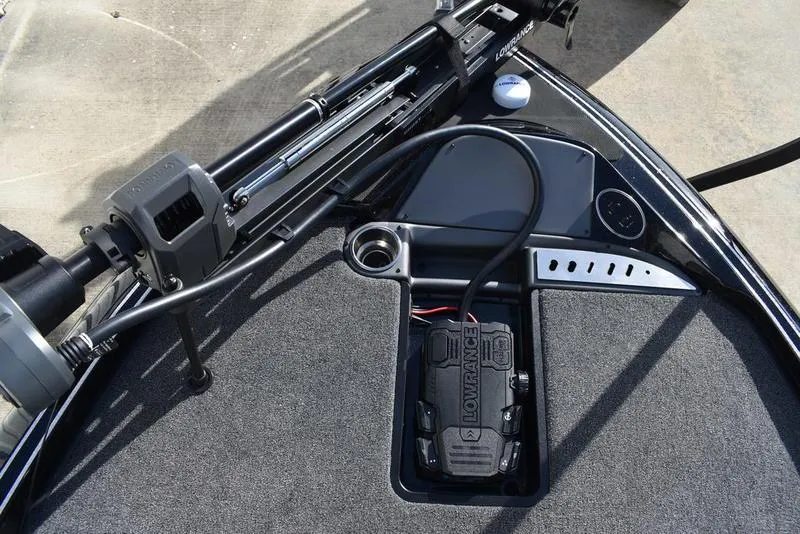 Slide: The Image of 2024 Triton 18 TrX boat dashboard with Lowrance electronics and trolling motor. - 12