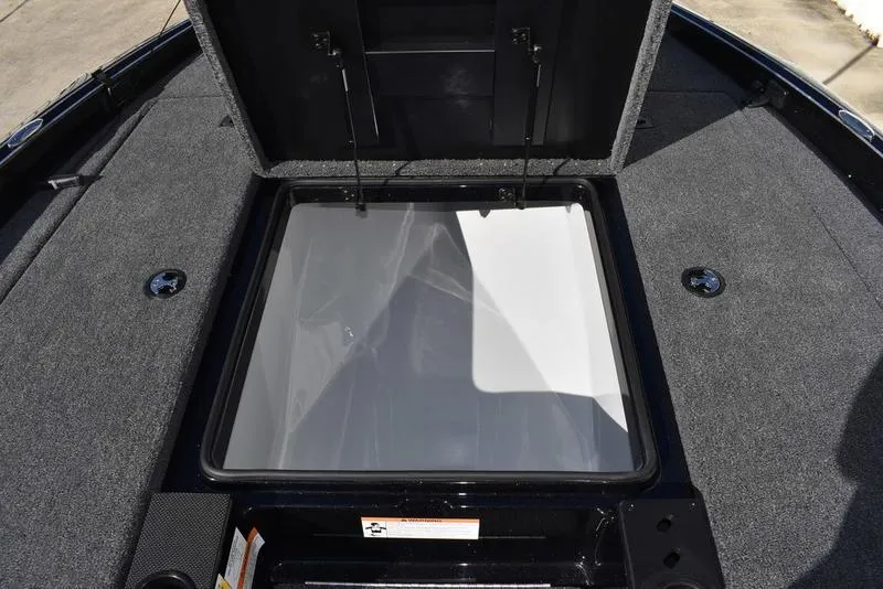 Slide: The Image of 2024 Triton 18 TrX boat storage compartment with open lid. - 15