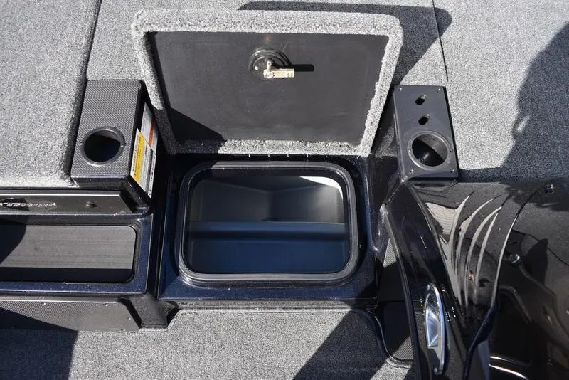 Slide: The Image of 2024 Triton 18 TrX boat storage compartment with open lid. - 17