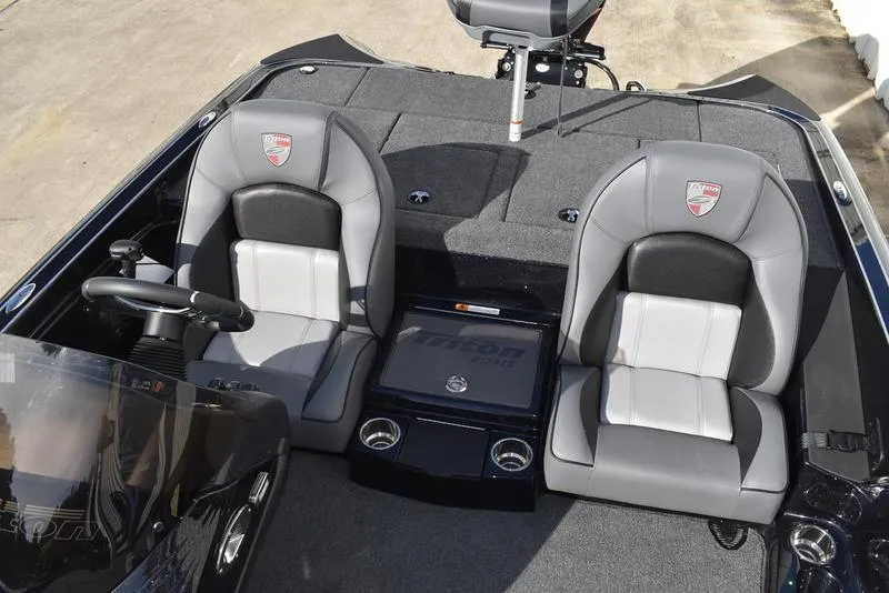 Slide: The Image of 2024 Triton 18 TrX boat interior with dual seats and steering console. - 19