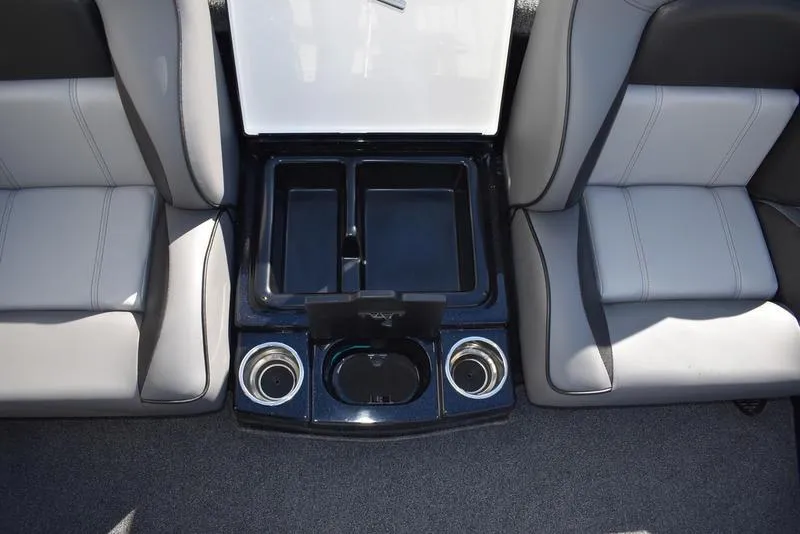 Slide: The Image of 2024 Triton 18 TrX boat interior with storage compartments and cup holders. - 21