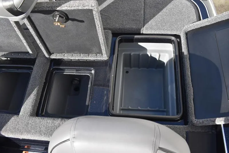 Slide: The Image of 2024 Triton 18 TrX boat storage compartments and seating area. - 27