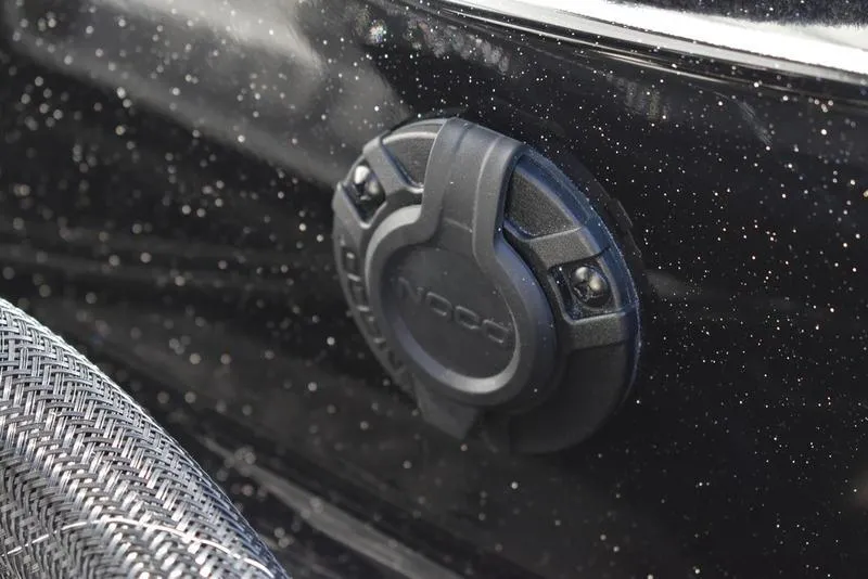 Slide: The Image of Close-up of a 2024 Triton 18 TrX boat's black exterior with a mounted accessory. - 30