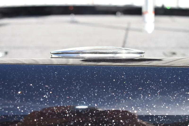 Slide: The Image of 2024 Triton 18 TrX boat with metallic finish and deck detail. - 32