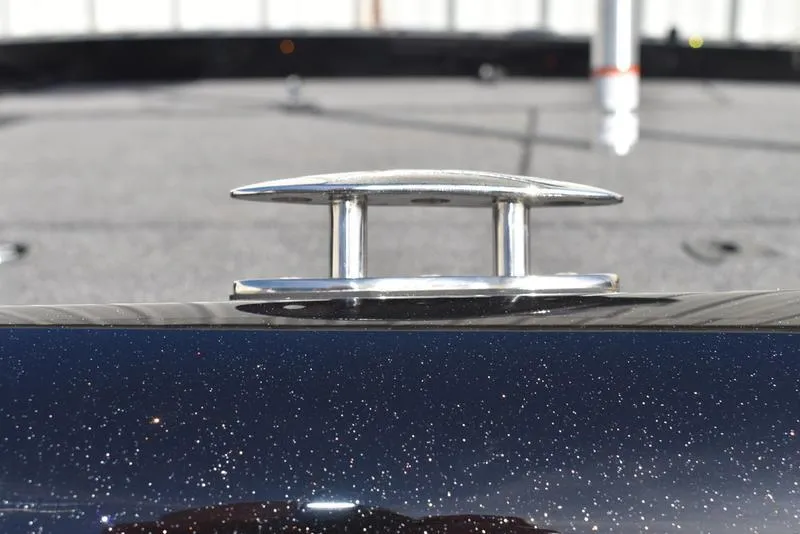 Slide: The Image of Close-up of a 2024 Triton 18 TrX boat cleat on a sparkling black surface. - 33