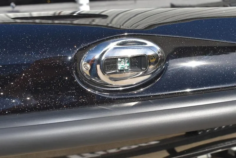 Slide: The Image of 2024 Triton 18 TrX boat detail with metallic black finish and chrome accent. - 5