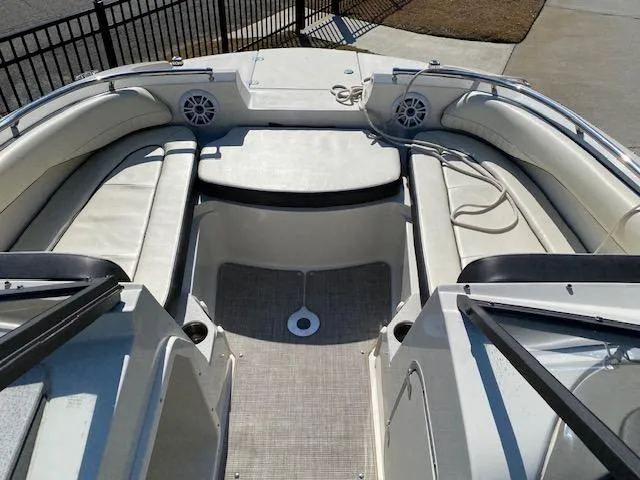 Slide: The Image of 2020 Stingray 201 DS boat interior with white seating and speakers. - 10