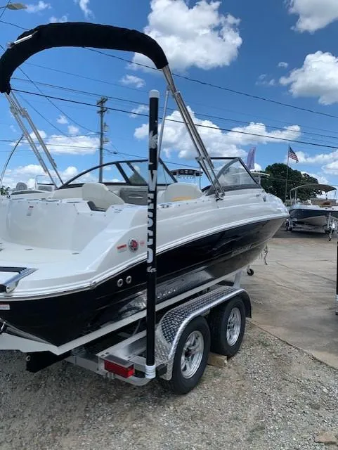 Slide: The Image of 2020 Stingray 201 DS boat on a trailer under a blue sky. - 15