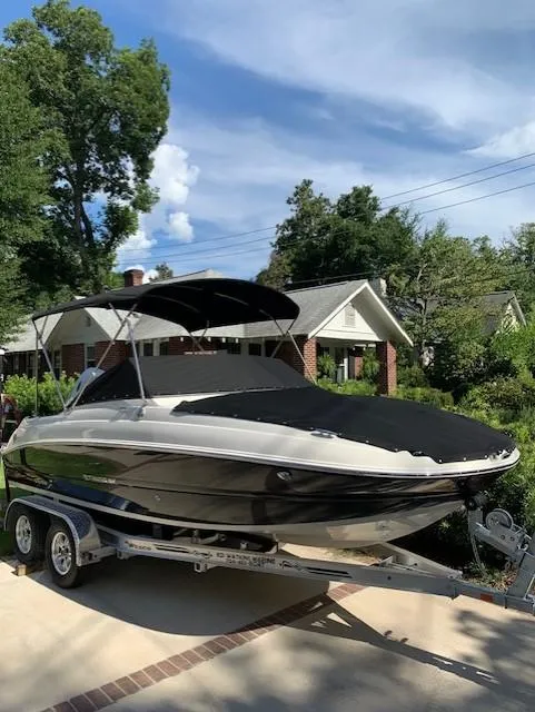 Slide: The Image of 2020 Stingray 201 DS boat on trailer with cover in residential driveway. - 16