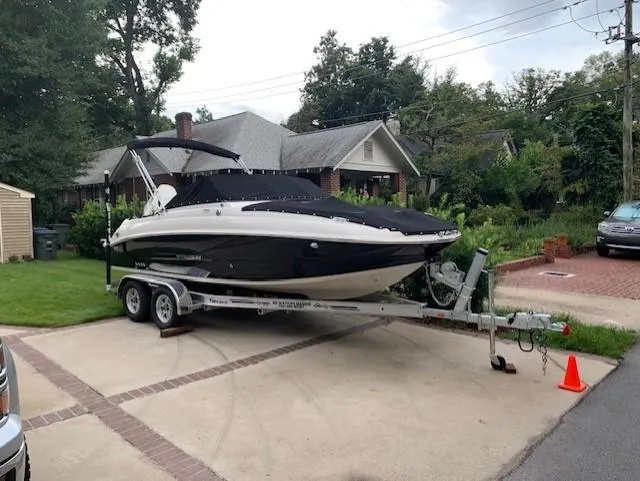 Slide: The Image of 2020 Stingray 201 DS boat on a trailer in a residential driveway. - 17
