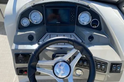 Slide: The Image of 2020 Stingray 201 DS boat dashboard with steering wheel and gauges. - 21