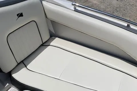 Slide: The Image of 2020 Stingray 201 DS boat interior seating with white upholstery. - 25