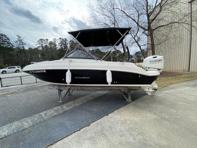 Slide: The Image of 2020 Stingray 201 DS boat with Suzuki outboard motor on a trailer. - 4