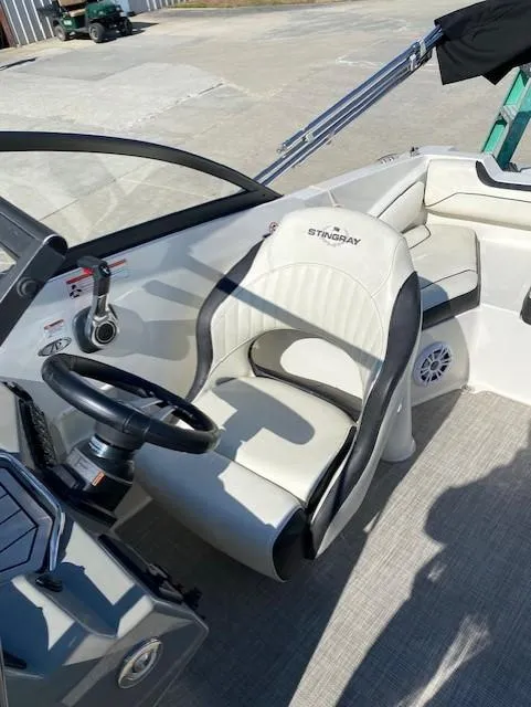 Slide: The Image of 2020 Stingray 201 DS boat interior with steering wheel and seating - 8