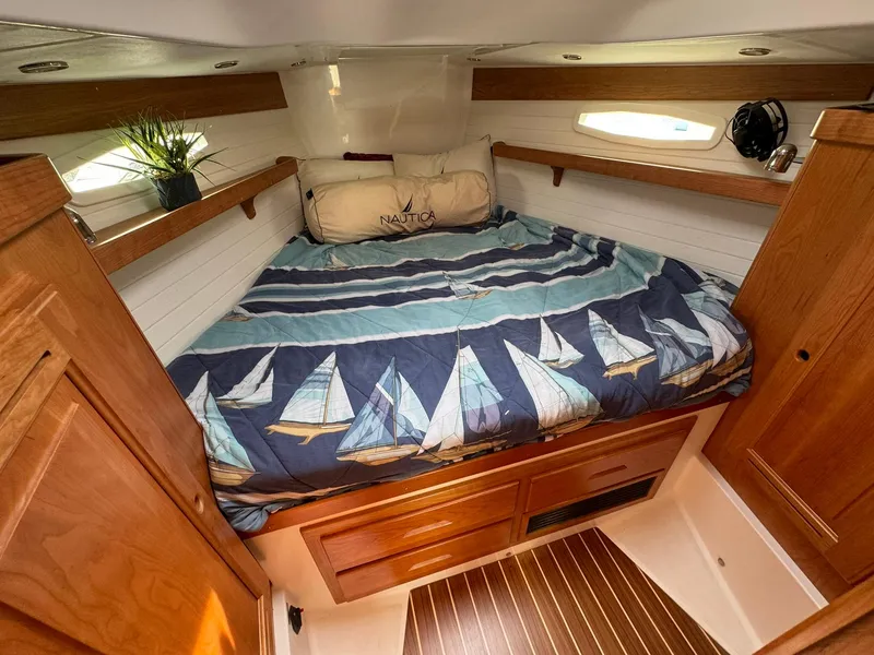 Slide: The Image of Cozy cabin interior of 2025 Tartan 365 yacht with nautical-themed bedding. - 13
