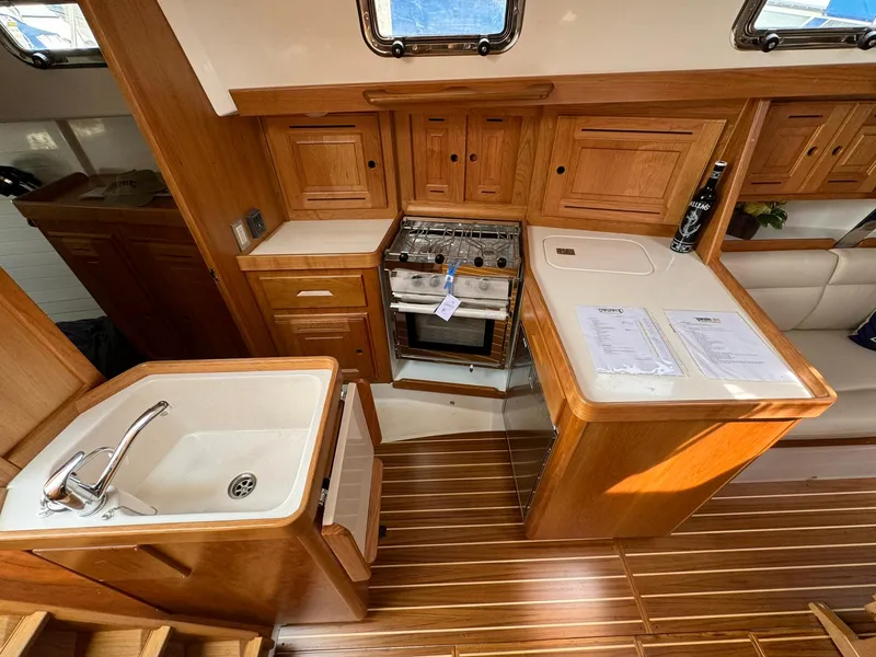 Slide: The Image of Luxurious Tartan 365 yacht kitchen with wooden cabinetry and modern appliances, 2025 model. - 17