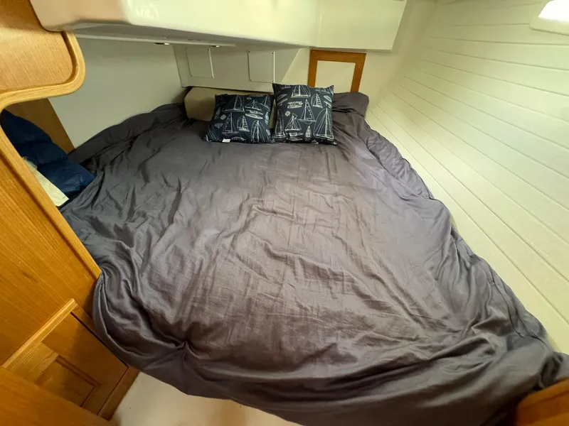 Slide: The Image of Cozy cabin bed in 2025 Tartan 365 yacht with nautical-themed pillows. - 20