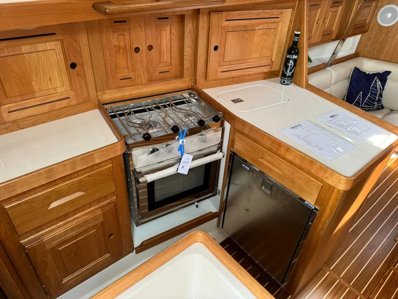 Slide: The Image of Cozy Tartan 365 yacht kitchen with wooden cabinetry and modern appliances, 2025 model. - 21