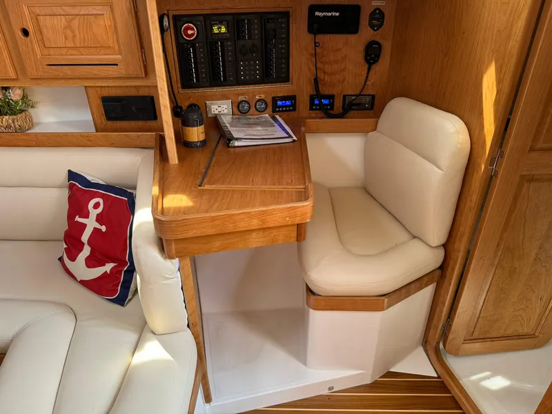 Slide: The Image of Cozy interior of 2025 Tartan 365 yacht with navigation station and seating. - 22