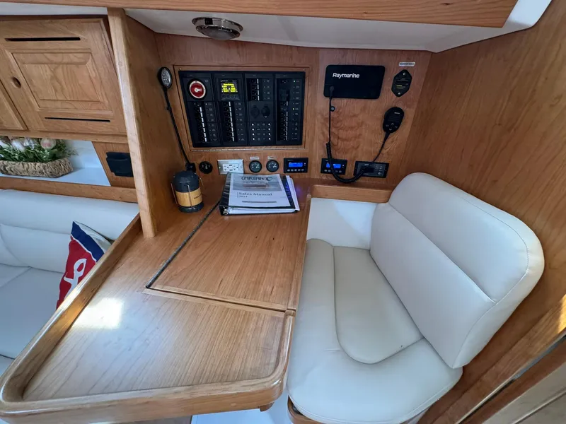 Slide: The Image of Navigation station in 2025 Tartan 365 yacht with control panel and seating. - 23