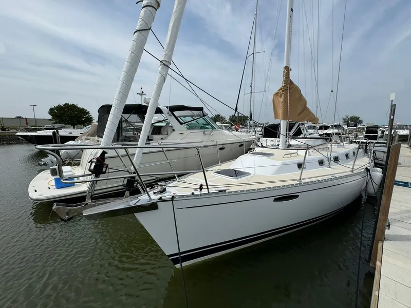 Slide: The Image of 2025 Tartan 365 sailboat docked at marina, alongside another boat, under a clear sky. - 3