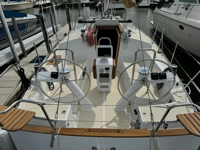Slide: The Image of 2025 Tartan 365 yacht cockpit with dual steering wheels and modern navigation equipment. - 9