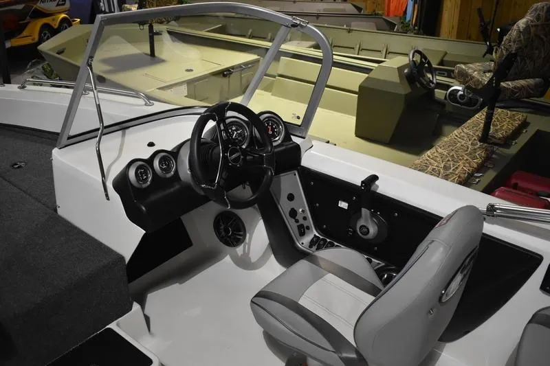 Slide: The Image of 2024 Triton 186 Allure boat interior with steering wheel and dashboard controls. - 100