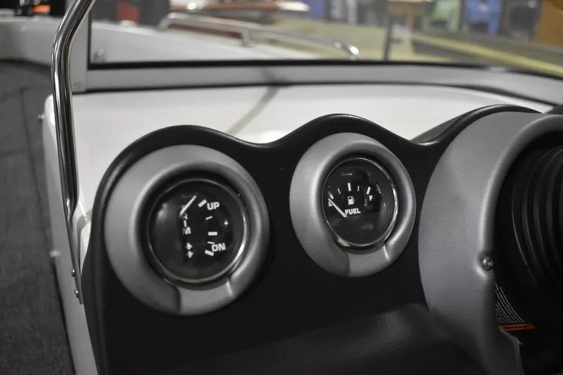 Slide: The Image of Dashboard gauges of 2024 Triton 186 Allure boat, showing trim and fuel levels. - 101