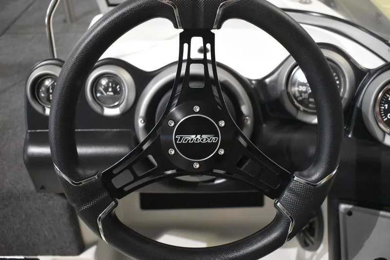Slide: The Image of Steering wheel of 2024 Triton 186 Allure boat with dashboard gauges. - 103