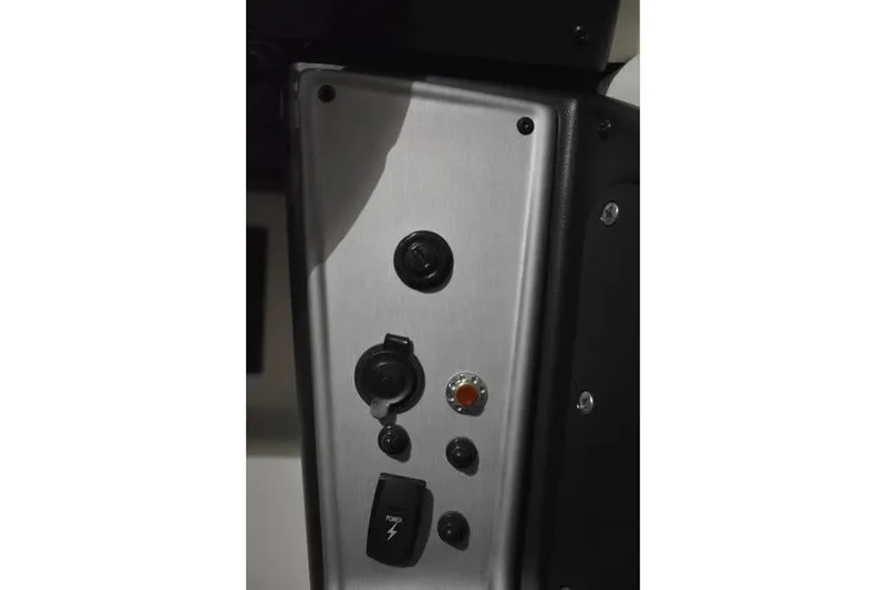 Slide: The Image of Control panel of 2024 Triton 186 Allure boat, featuring switches and buttons. - 107