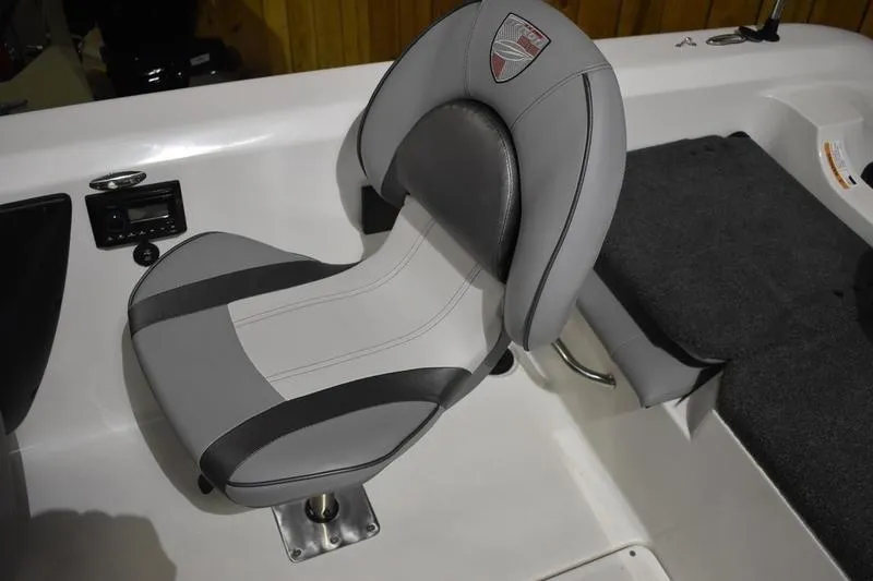 Slide: The Image of 2024 Triton 186 Allure boat seat, featuring sleek gray and black design with emblem. - 111