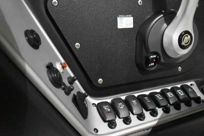 Slide: The Image of Control panel of 2024 Triton 186 Allure boat with switches and throttle lever. - 112