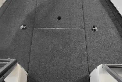 Slide: The Image of 2024 Triton 186 Allure boat foot pedal and remote control on carpeted surface. - 12