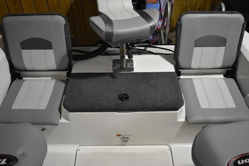 Slide: The Image of 2024 Triton 186 Allure boat interior with gray seating and central swivel chair. - 120